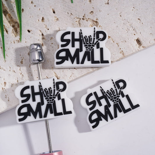 Silicone Focal Beads with Black Text "SHOP SMALL" and Skull Hand on White Background