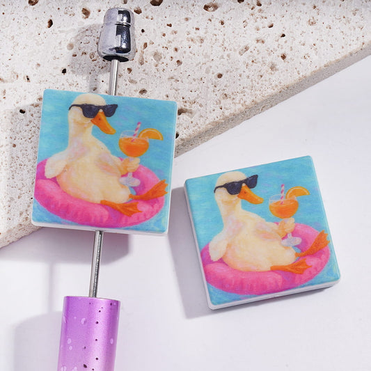 Silicone Focal Beads with Duck Wearing Sunglasses & Holding Orange Juice Glasses on Pink Swim Ring, Flat Square Shape