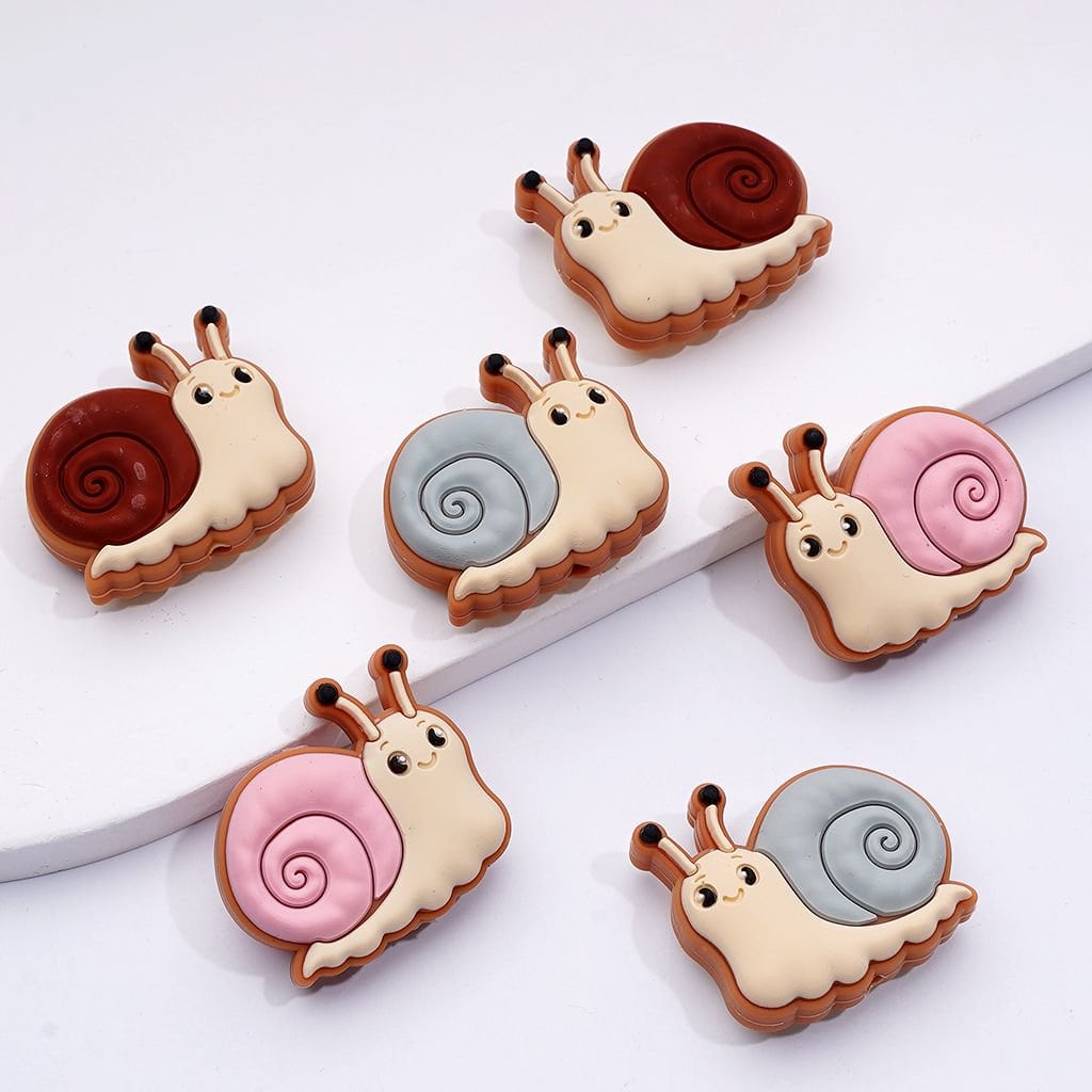 Set of six colorful snail-shaped cookies on a white background

