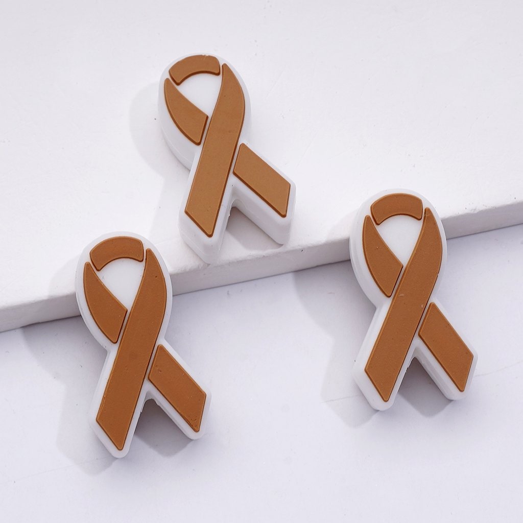 Brown awareness ribbon pins on a white background


