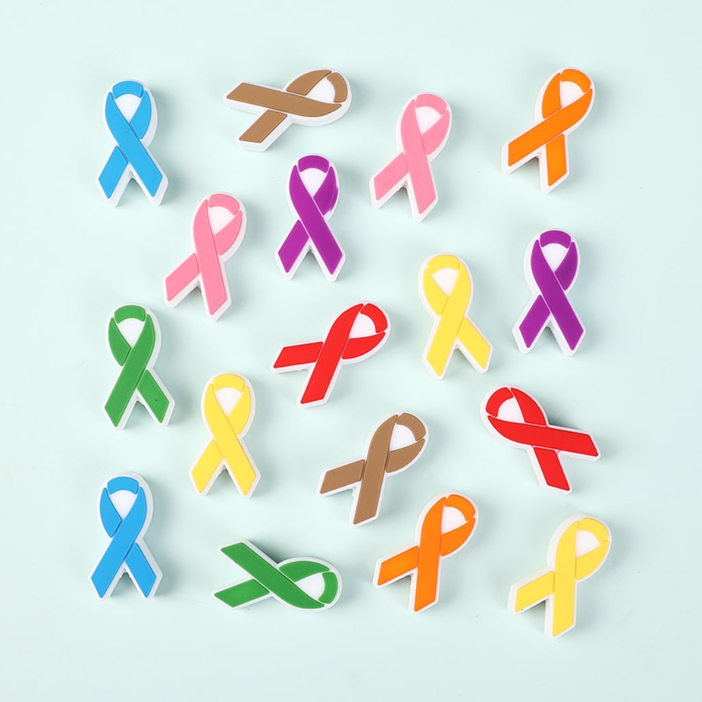 Collection of colorful awareness ribbons on a light blue background

