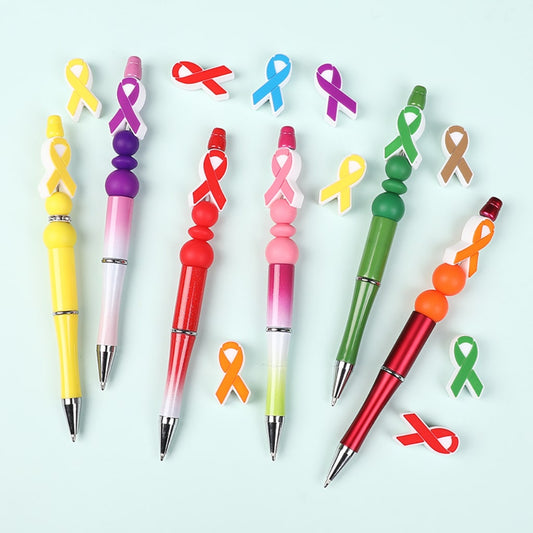 Colorful pens with ribbon designs on a light blue background

