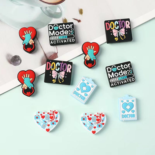 Collection of colorful doctor-themed pins on a light green background

