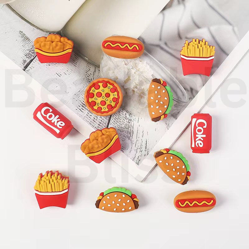 Collection of food-themed erasers on a newspaper background

