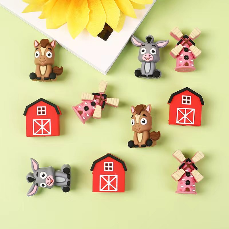 Set of colorful farm-themed magnets on a light green background

