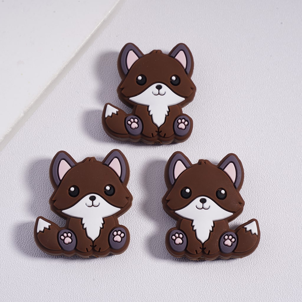 Three cartoon-style fox figurines on a light gray background