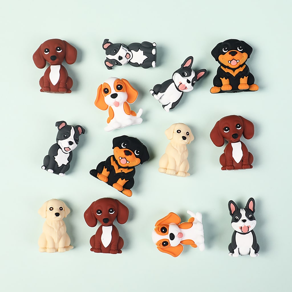 Collection of dog-shaped figurines on a light blue background