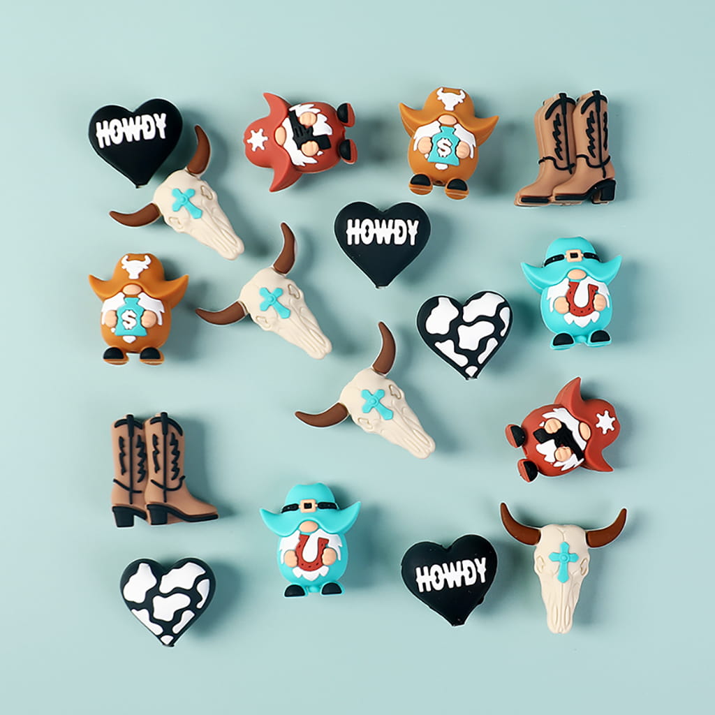 Collection of decorative magnets with cowboy-themed designs on a light blue background