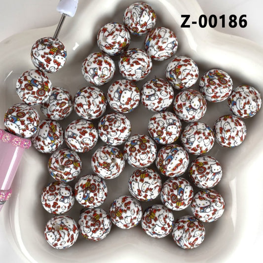 Decorative beads with Hello Kitty design on a white plate

