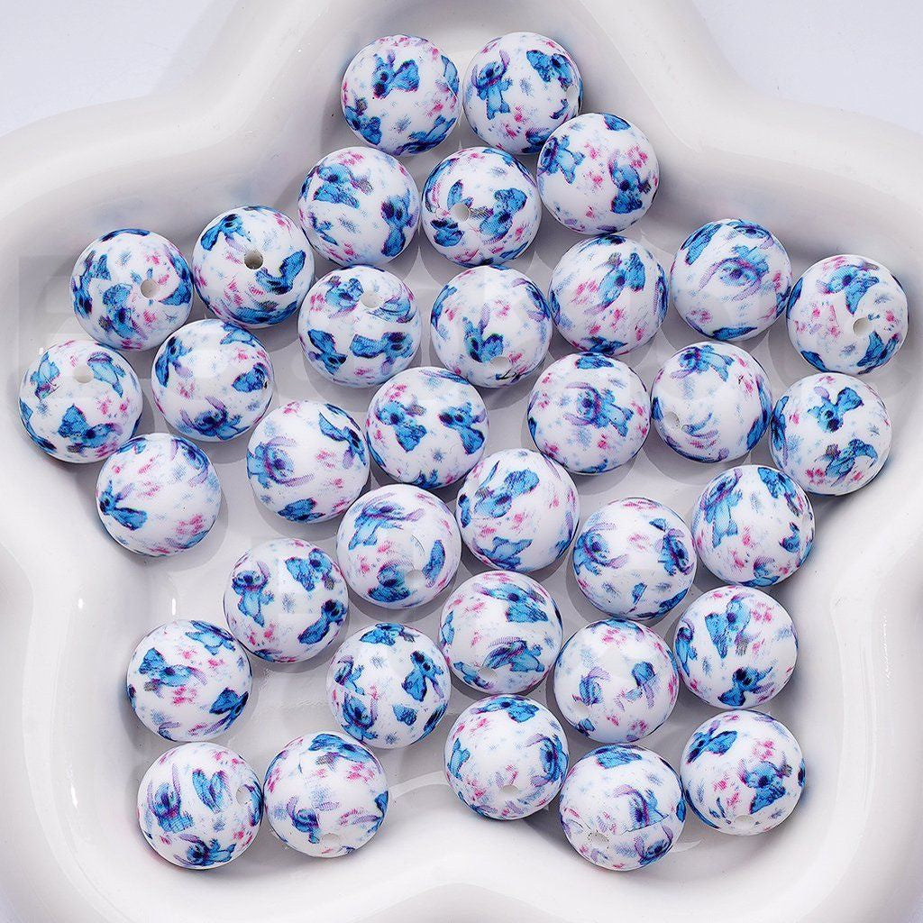 White beads with blue and pink floral patterns on a white background

