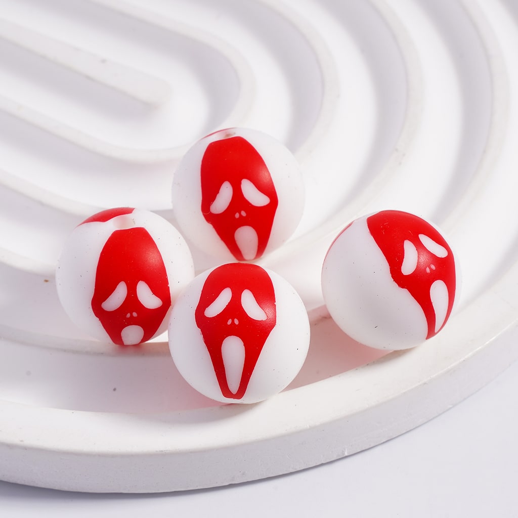 Red and white decorative items resembling eyes and mouths on a white background

