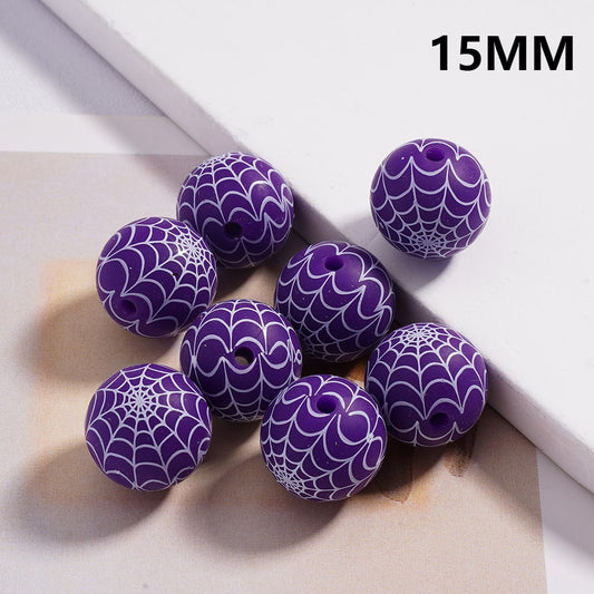 Purple beads with spider web pattern on a light background, labeled '15MM'.

