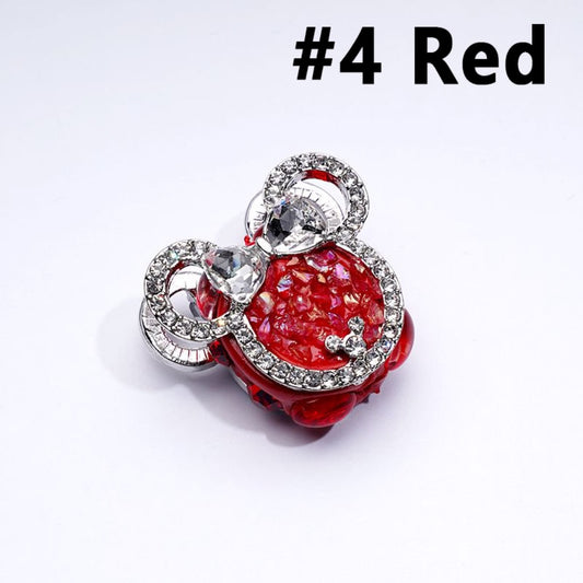 A collection of silver alloy mouse head-shaped bows with clear and colorful rhinestones and clay beads.

