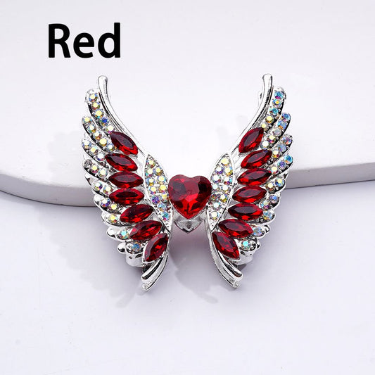 Red gemstone wing-shaped earrings on a white background with 'Red' text above.

