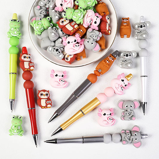 Colorful pens with animal-shaped rubber erasers on a white surface