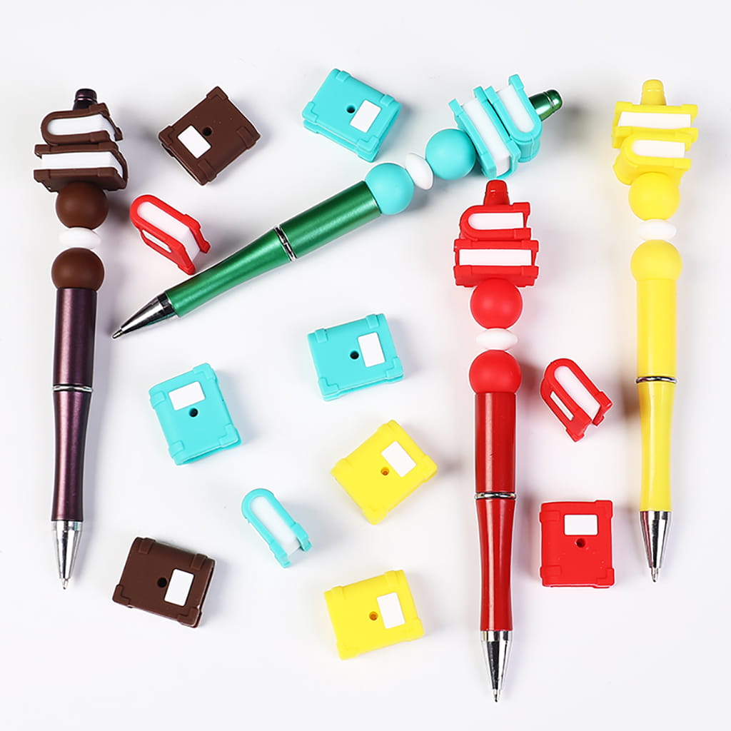 Colorful pens with various shaped and colored pen caps on a white background