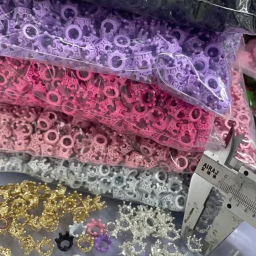 Assorted colorful lace strips with a caliper for measurement on a white background

