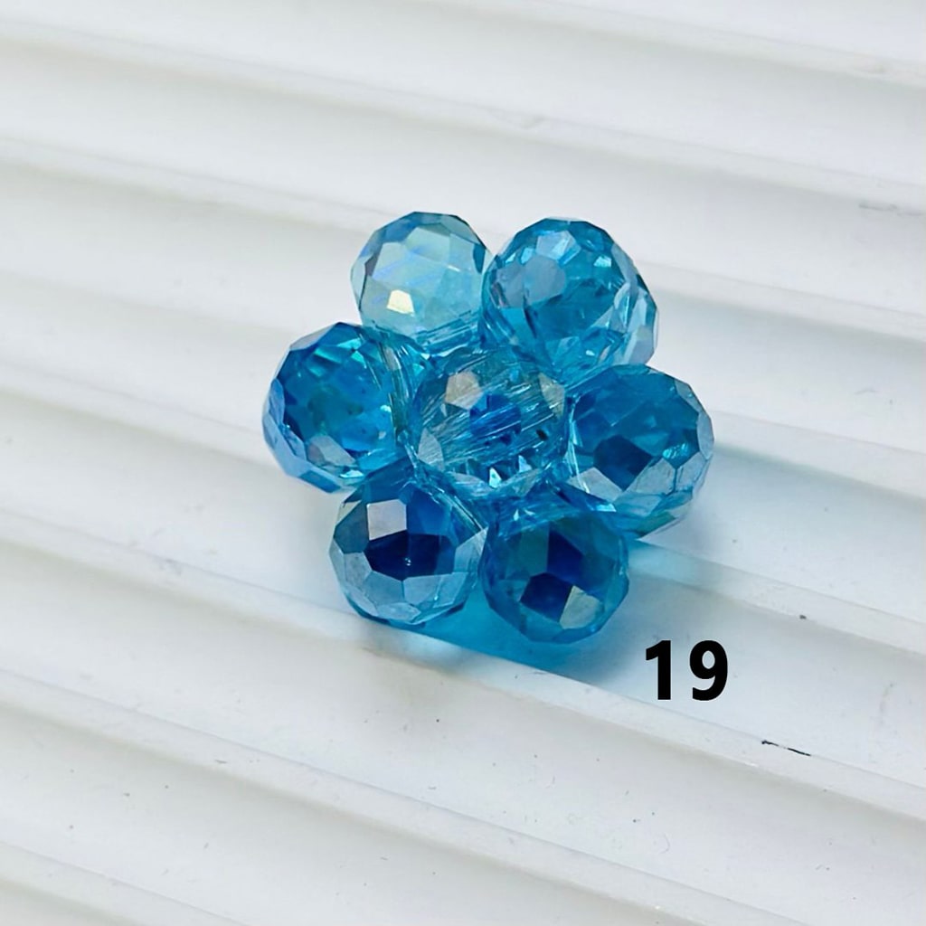 Blue faceted bead on a white background

