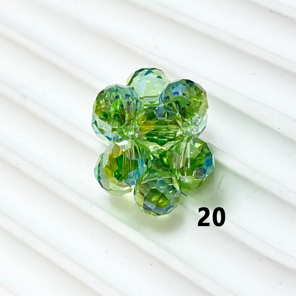 Green beaded flower on a white background

