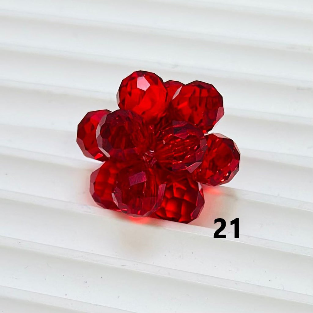 Red flower-shaped object on a white background


