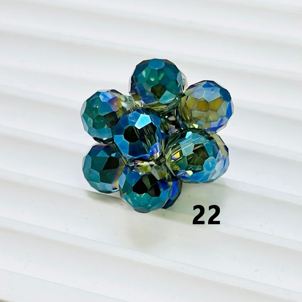 Multicolored beaded flower ring on a white background

