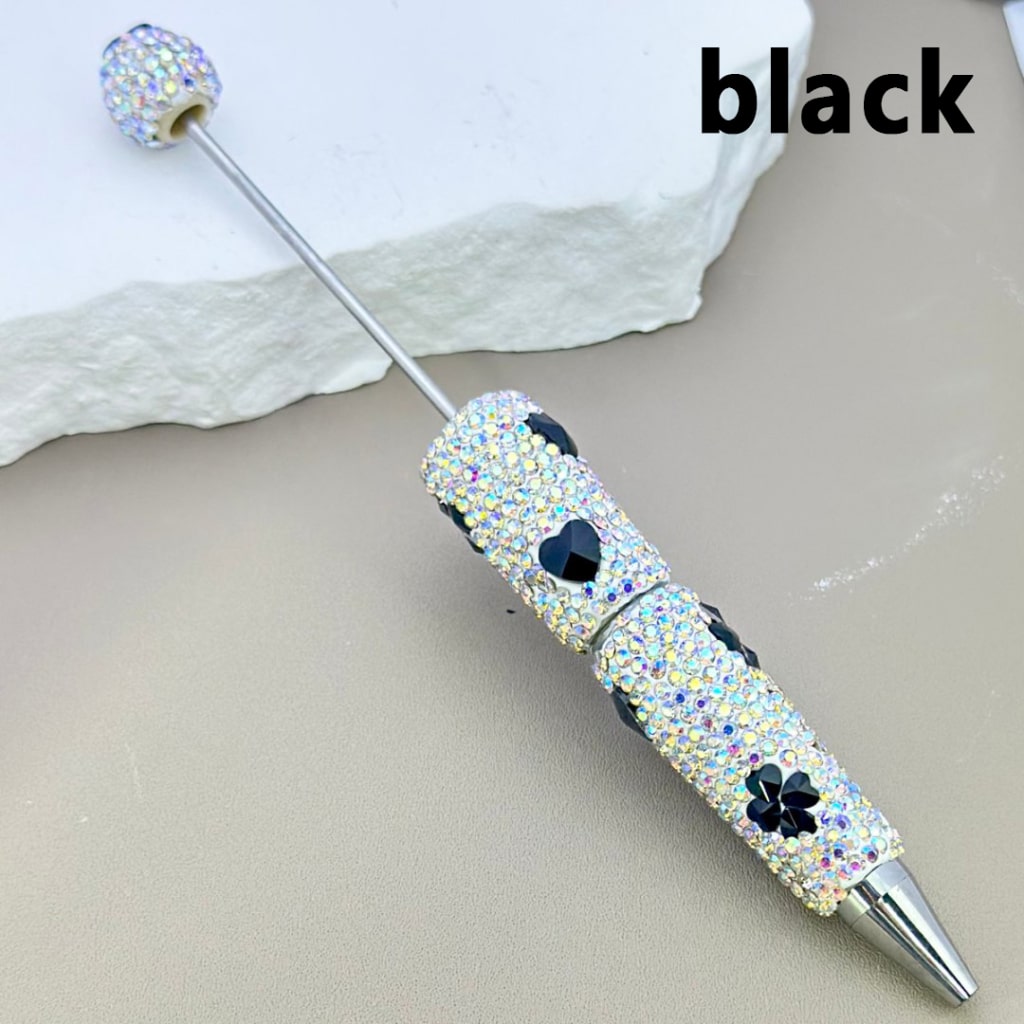 Decorative pen with gemstones on a light background