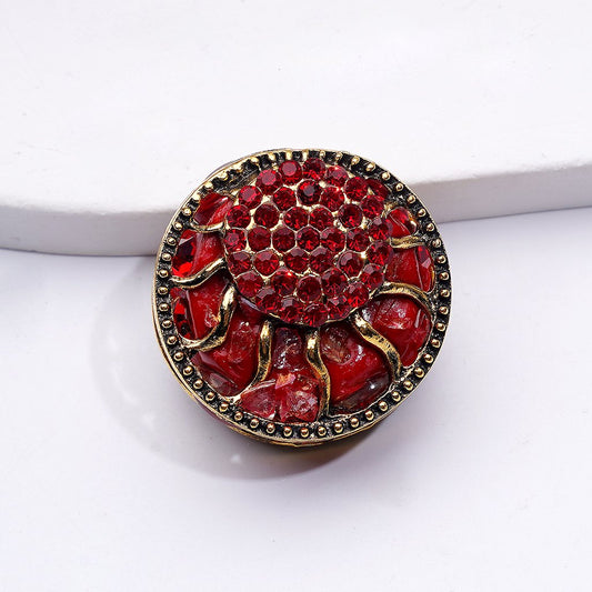Red crab-shaped object with gold accents on a white background

