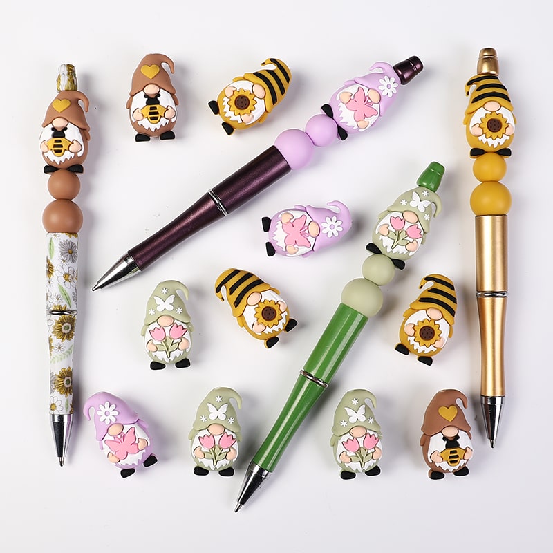 Set of decorative pens with cartoon-like character designs on a white background