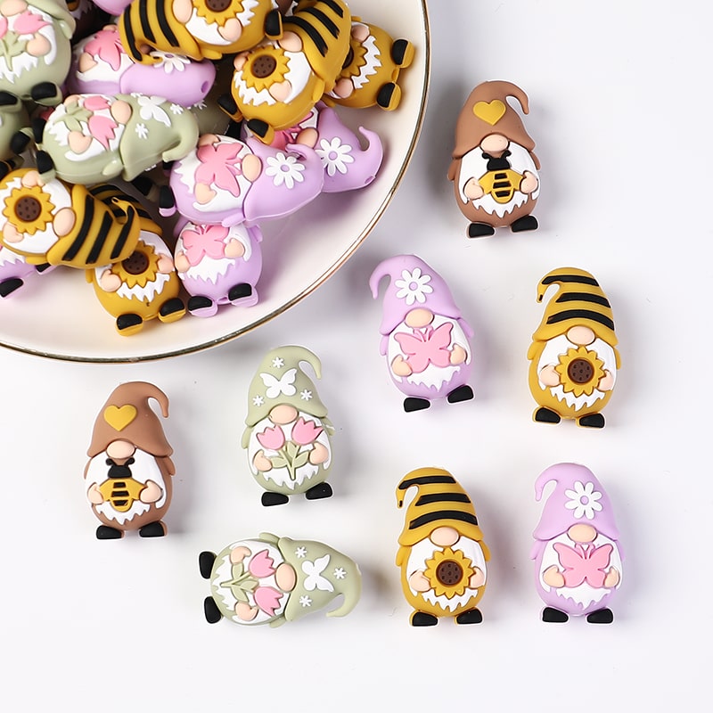 Decorative gnomes with various designs on a white surface