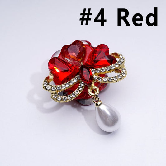 A collection of decorative gold alloy bowknots with colorful hearts, clear rhinestones, white pearls, and clay beads in various colors.

