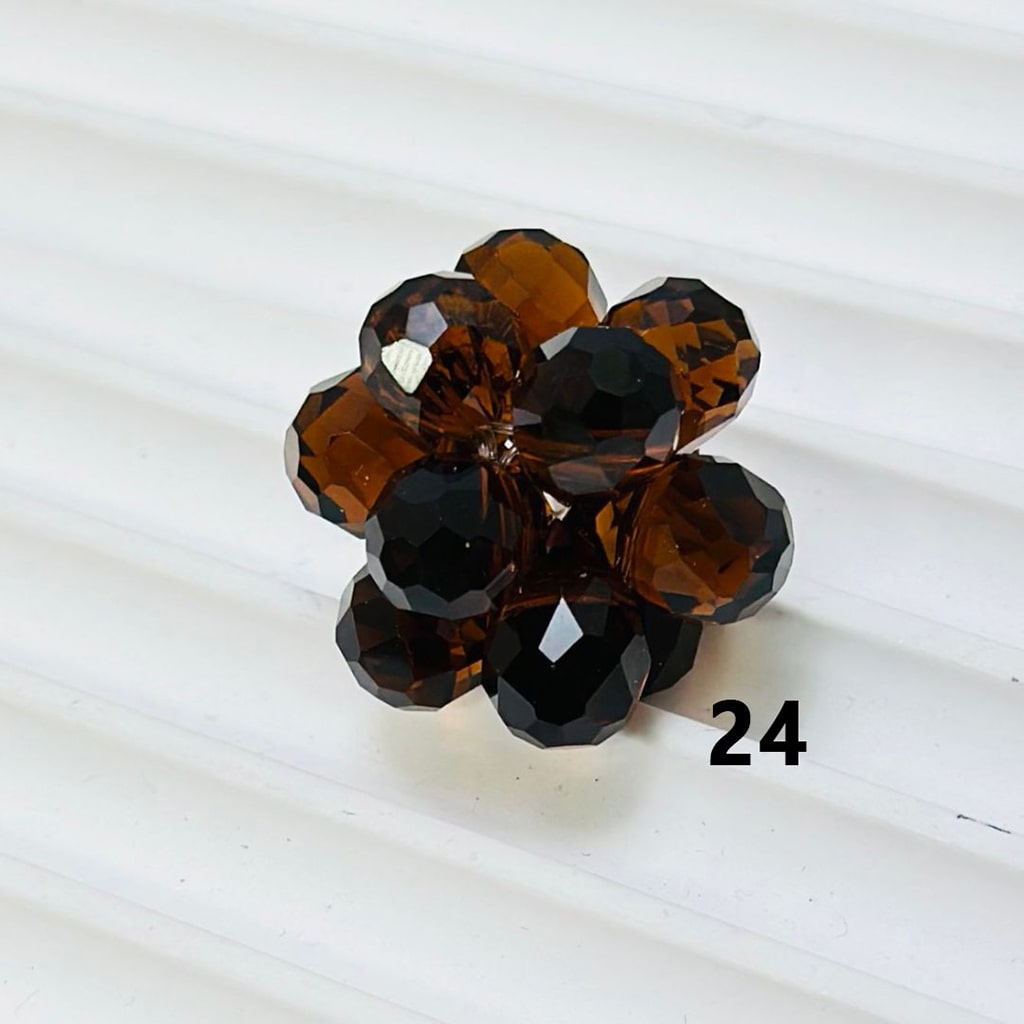 Brown flower-shaped jewelry piece on a white background

