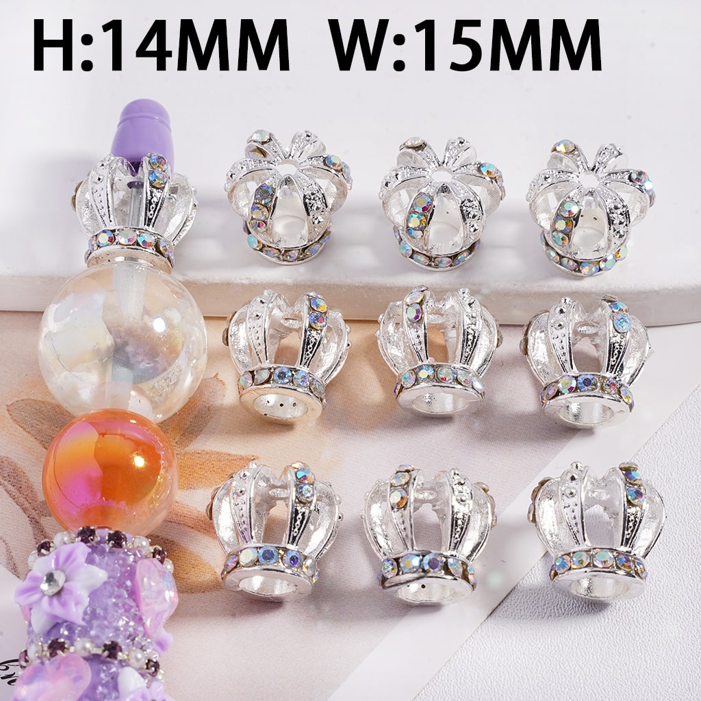 Decorative crown-shaped beads with crystal accents on a white background