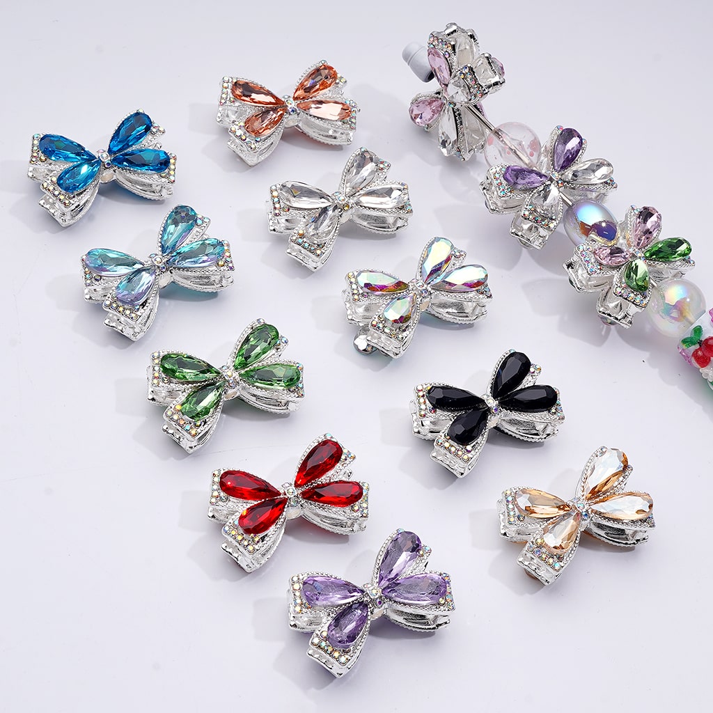 Colorful bow-shaped jewelry pins on a white background

