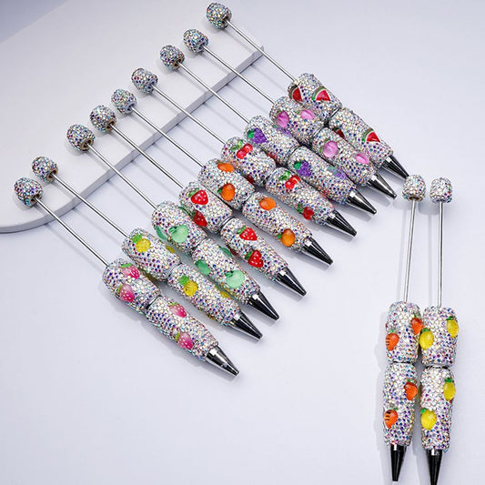 Decorative pens with colorful gemstones and black accents on a white background