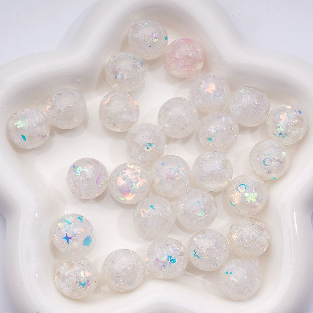 White marbles with iridescent flecks on a white background

