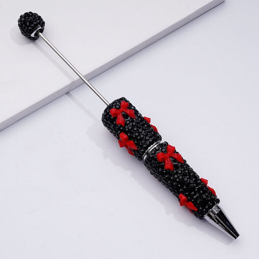 Decorative pen with black embellishments on a white surface

