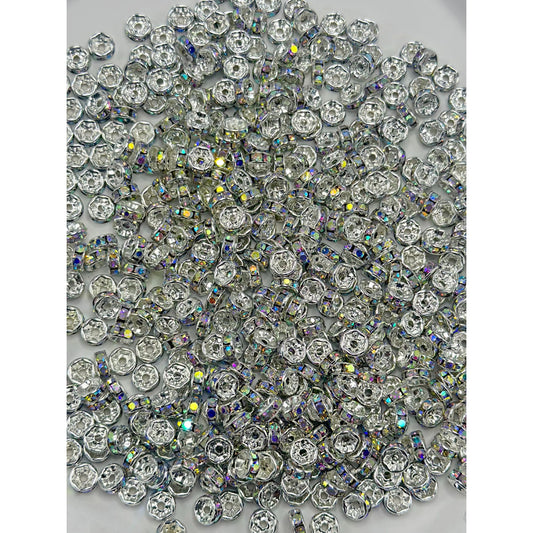 A collection of flat round metal spacers with multicolored rhinestones

