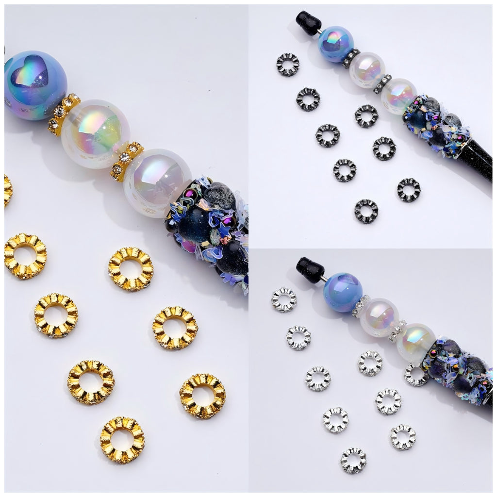 An assortment of round spacer beads in gold, silver, and gun black colors with clear rhinestones, displayed on a white background.

