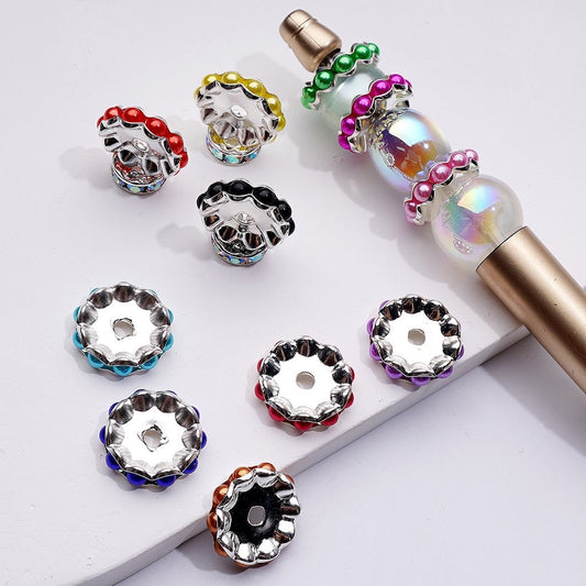 Decorative bottle caps with colorful gemstones on a white background

