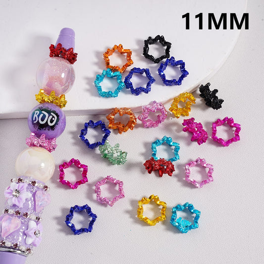 Colorful star-shaped hair ties with a 'BOO' bead on a white background

