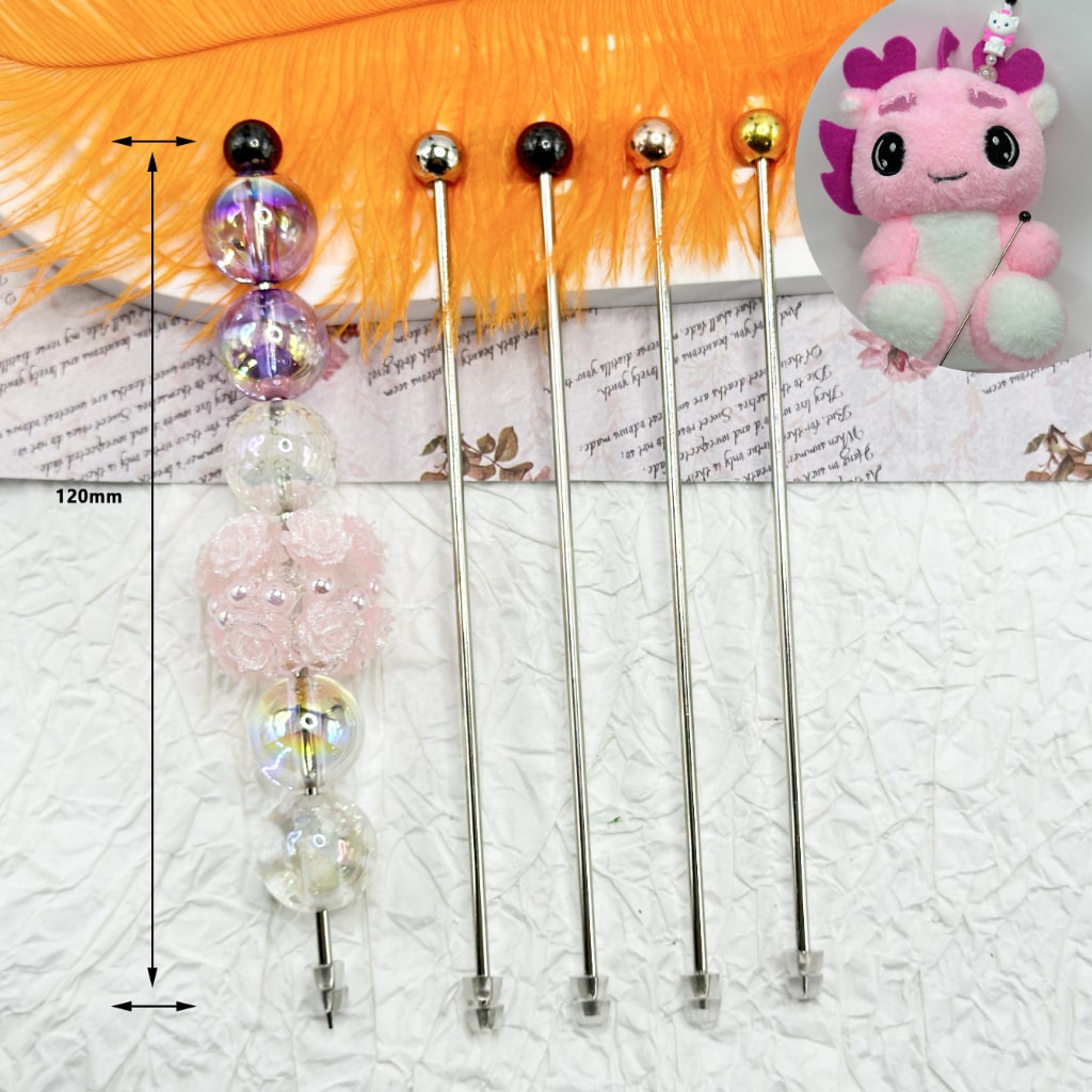 A selection of Beadable Ami Sticks DIY Metal Bastinades placed on a surface, with decorative beads attached to their ends.

