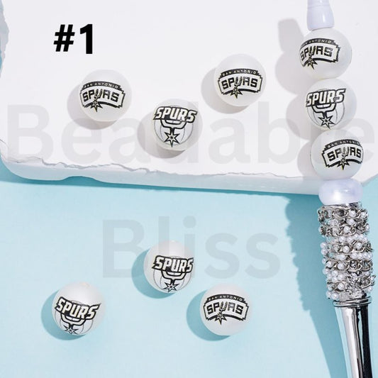 Spurs-themed hair tie with multiple loops on a light blue background

