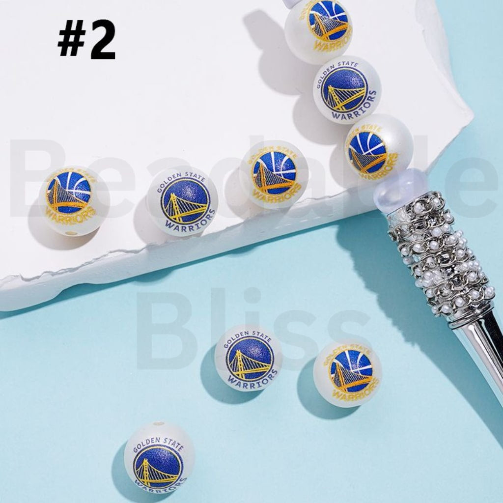 Set of Golden State Warriors earrings on a light blue background with a white box.

