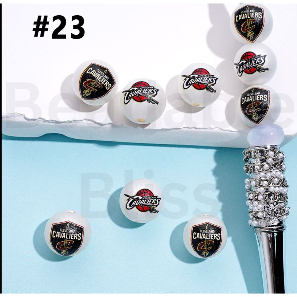 Cleveland Cavaliers branded golf balls on a stand with a decorative golf club.

