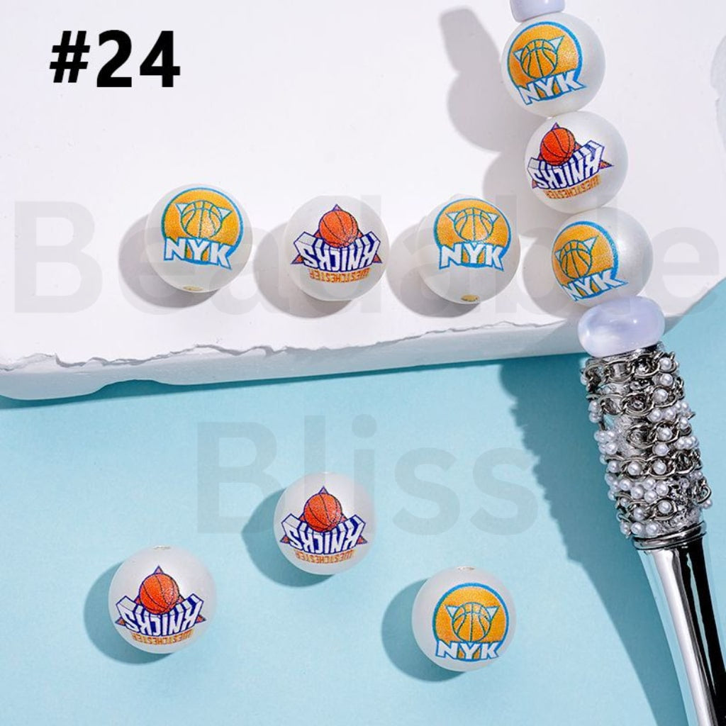 Basketball-themed erasers on a white tray with a decorative pen on a blue background.

