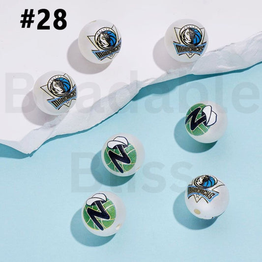 Table tennis balls with Dallas Mavericks logo on a light blue background

