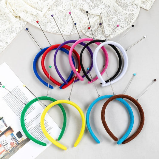 A selection of colorful plastic flocked hair bands displayed on a surface.

