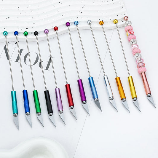Set of colorful metal tools with beaded handles on a white background

