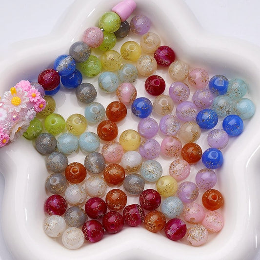 Assorted colorful beads in a white dish

