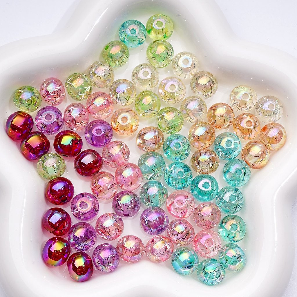 Assorted colorful beads on a white plate


